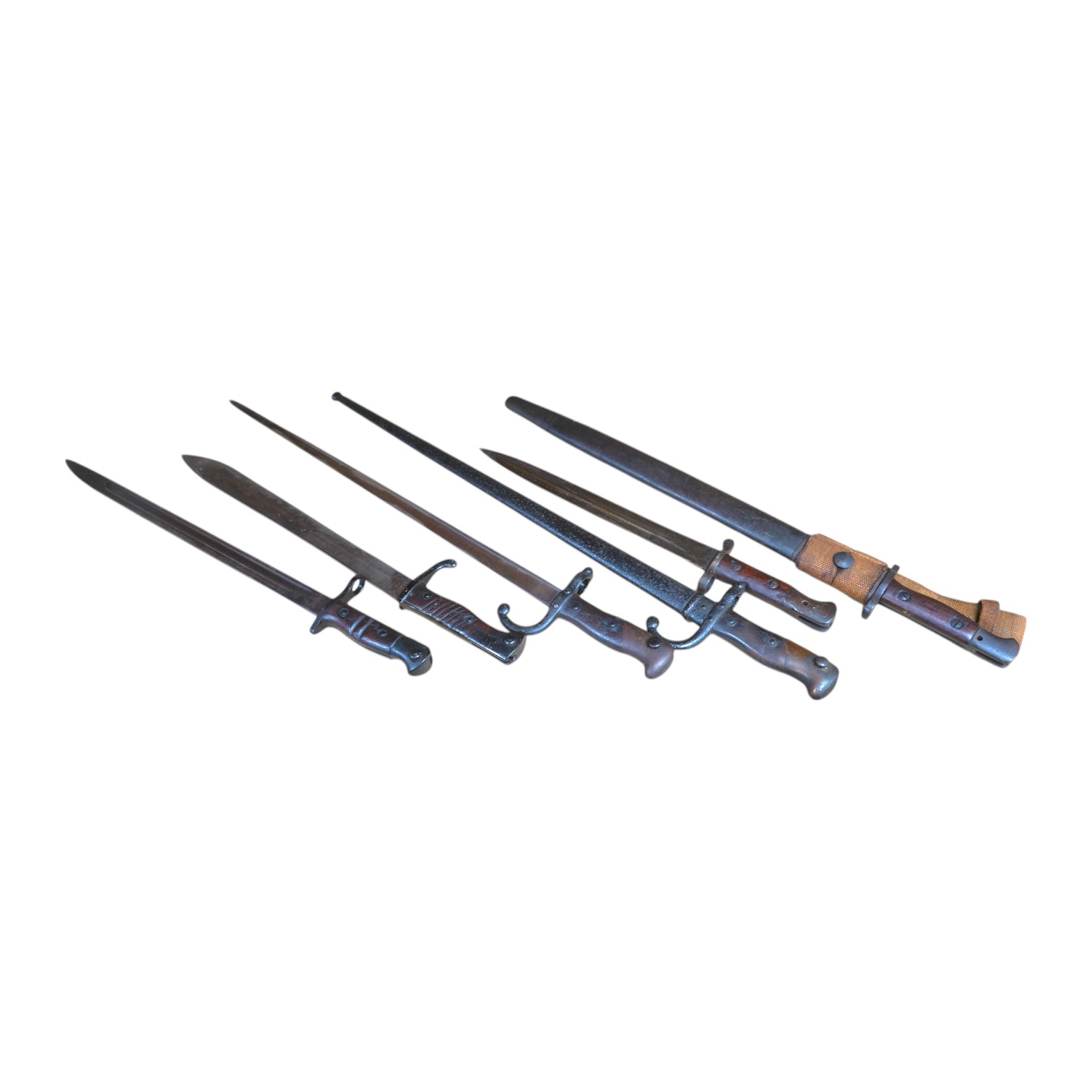 Six assorted bayonets; a 1907 pattern in its scabbard, a 1903 Wilkinson bayonet (no scabbard), two Gras bayonets (one in scabbard), a German Mauser bayonet, and a Remington First World War bayonet. Condition - poor to fa